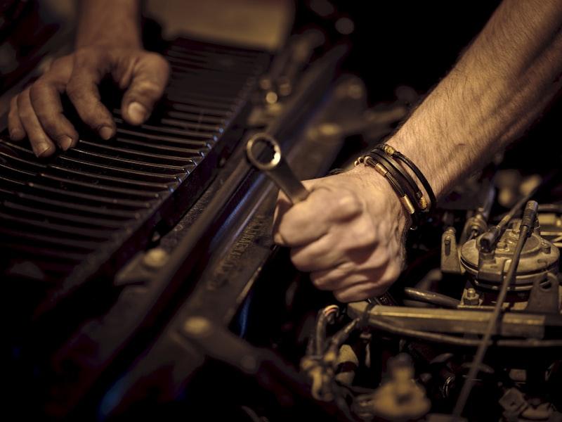 Qualified mechanic servicing a vehicle in a professional garage
